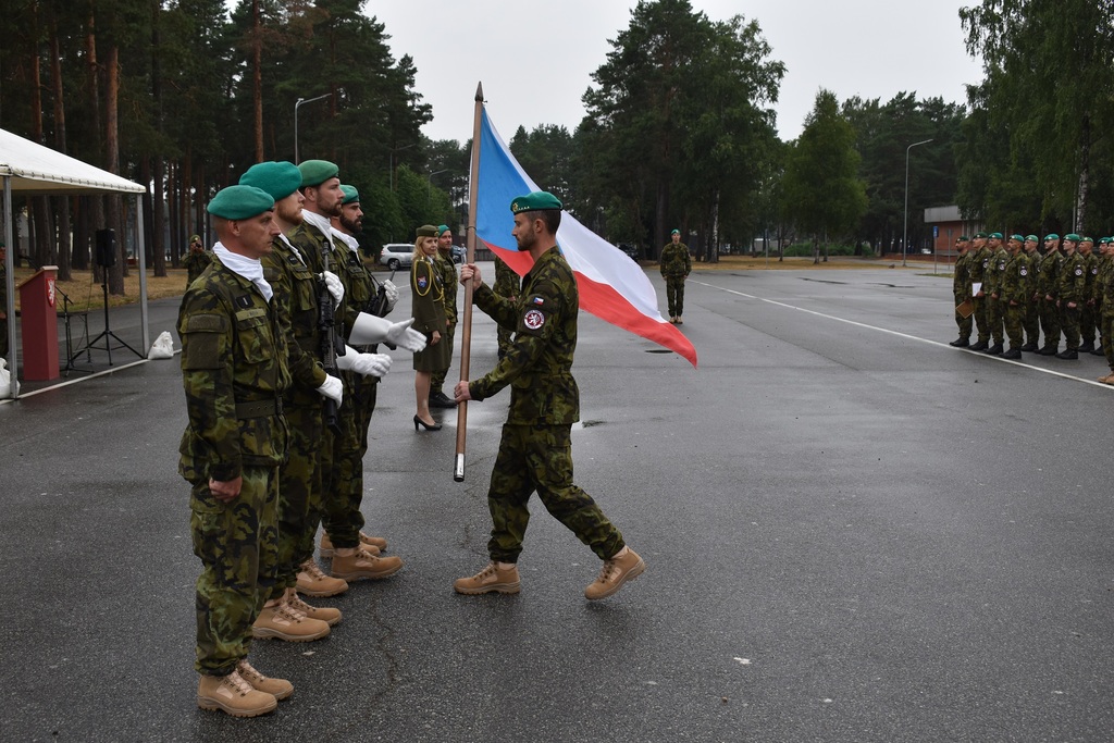 Kapitán Kurfiřt symbolicky předává českou vlajku jednotce