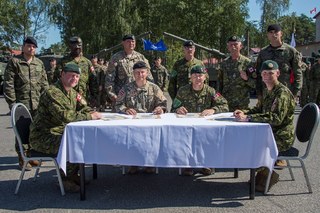 Slavnostní podpis dokumentace při předání a převzetí funkce velitele uskupení eFP, zleva podplukovník MacBeth, plukovník Lejins, plukovník Major a podplukovník French