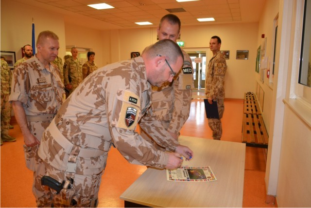 Velitel 18. polního chirurgického týmu podepisuje certifikát k předání operačního úkolu 