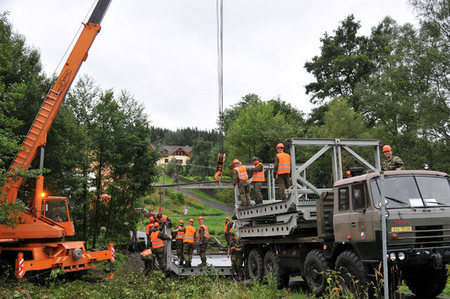 Engineers setting a temporary bridge
