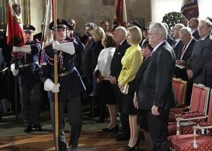 The Castle Guard parades historical flags in front of outgoing president Vaclav Klaus and new president Milos Zeman and their families
