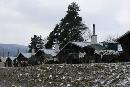 Camouflaged light vehicles of Belgian soldiers in front of their temporary quarters at Podvori