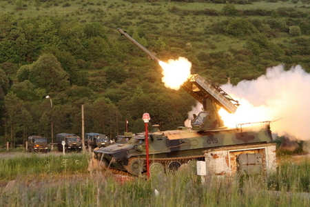 Muzzle flash, smoke and gasses accompany the discharge of the missile