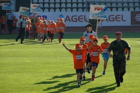Hundreds of children gather at a sporting event supported by the military
