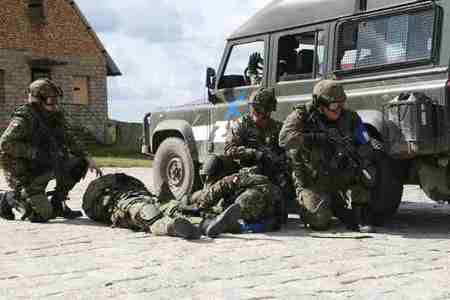 Polish policemen take care of their wounded colleagues