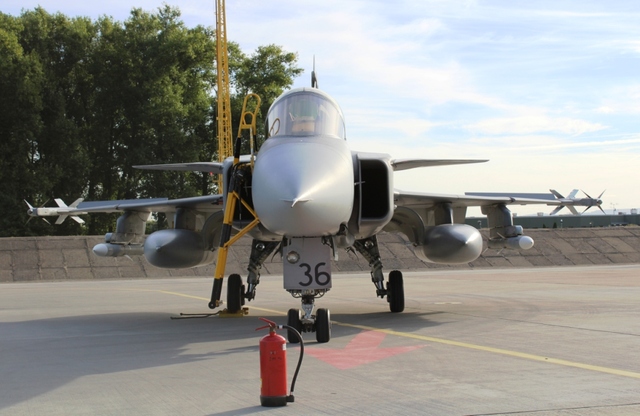 Letoun JAS-39 Gripen vyzbrojen raketami AIM-9 Sidewinder, AIM-120 AMRAAM a podvěšen přídavnými nádržemi pro přelet na islandský Keflavík