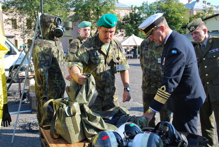 General examines chemical protection suits and gas masks