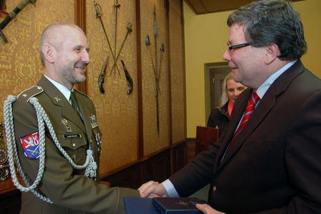 Ludek Kolesa receives the decoration from Alexandr Vondra